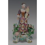 A Bow figure, Allegorical of Summer, modelled with a lady wearing a fancy dress,