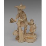 A Japanese ivory sectional okimono, carved as a fisherman, his young son his assistant, they stand,
