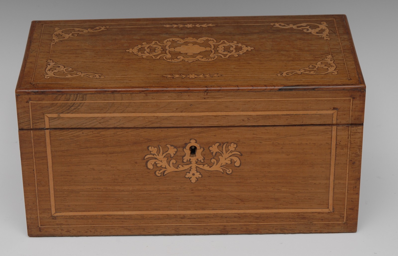 A 19th century rosewood and marquetry rectangular tea caddy, inlaid with leafy scrolls,