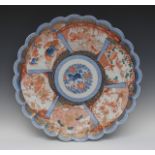 A large Japanese shaped circular Imari charger, the centre with mystical beast,