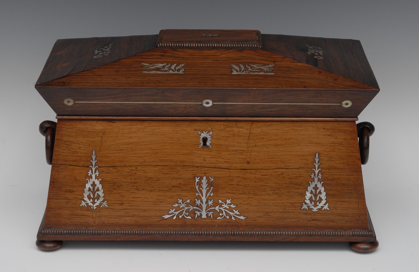 An early Victorian rosewood and mother of pearl marquetry sarcophagus tea caddy,