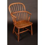 A 19th century elm and ash Windsor elbow chair, low hooped back, U-shaped armrail, saddle seat,