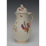 An English creamware pear shaped coffee pot and cover, painted with polychrome flower spray,