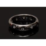 A modern design platinum and diamond eternity ring,