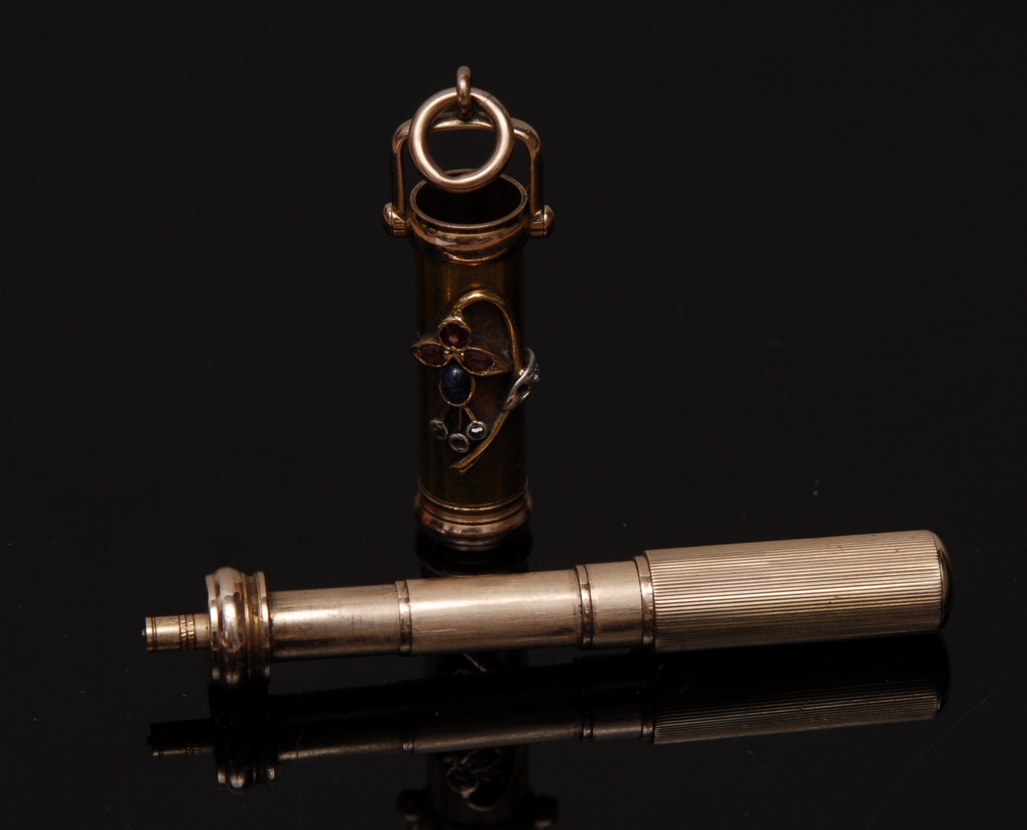 An unusual early 20th century diamond, sapphire and ruby mounted yellow metal propelling pencil,