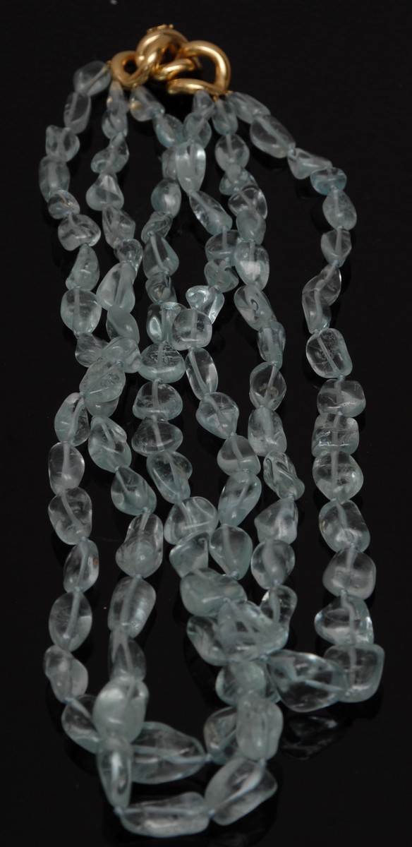 An aquamarine three strand polished pebble bead necklace,