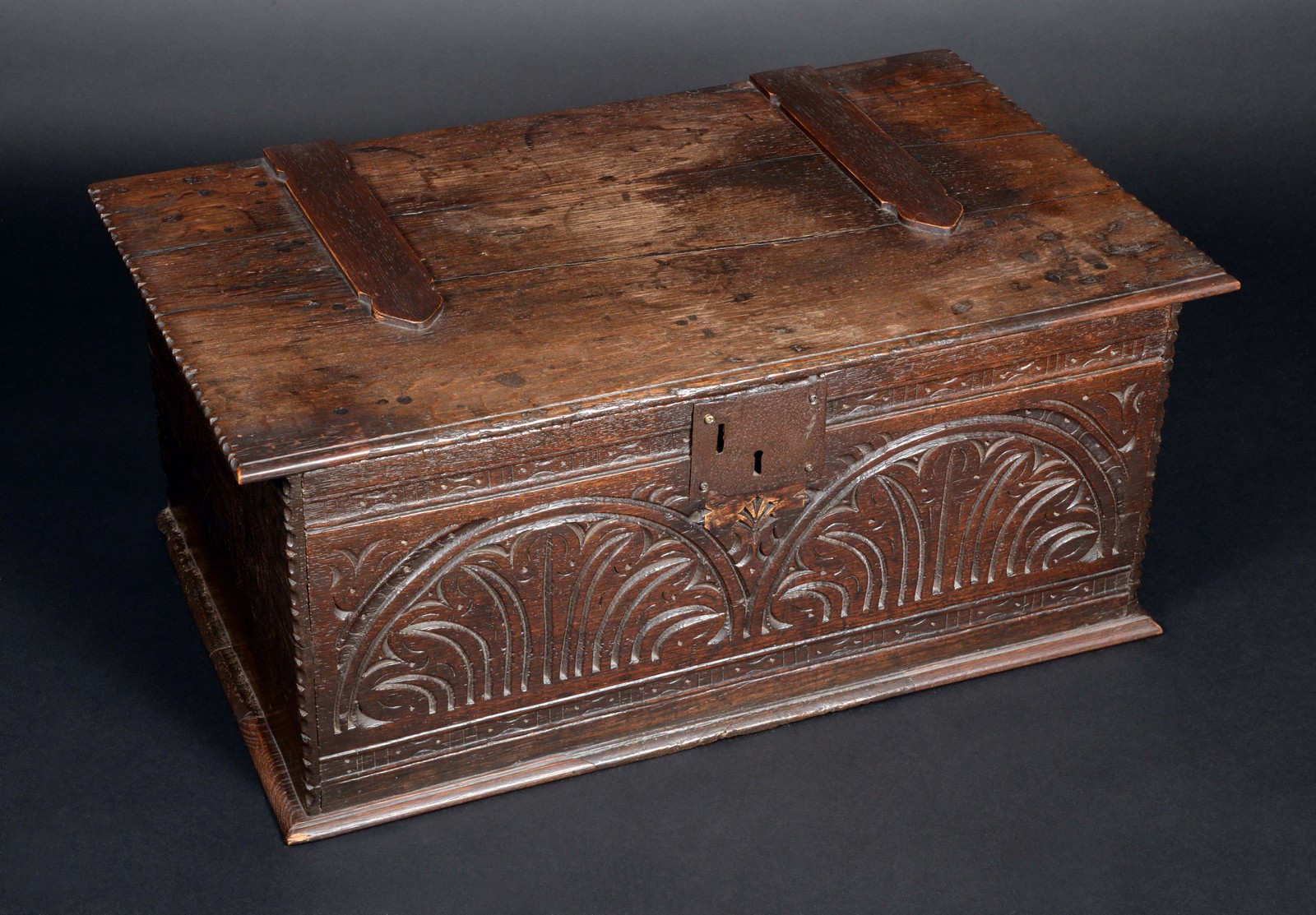 An early 18th century oak rectangular bible box, hinged cover with notched border,