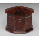 A 19th century tortoiseshell octagonal tea caddy, hinged cover centred by a vacant cartouche,