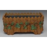 An English majolica planter, applied in relief with ivy, the ground in the form of a rustic fence,
