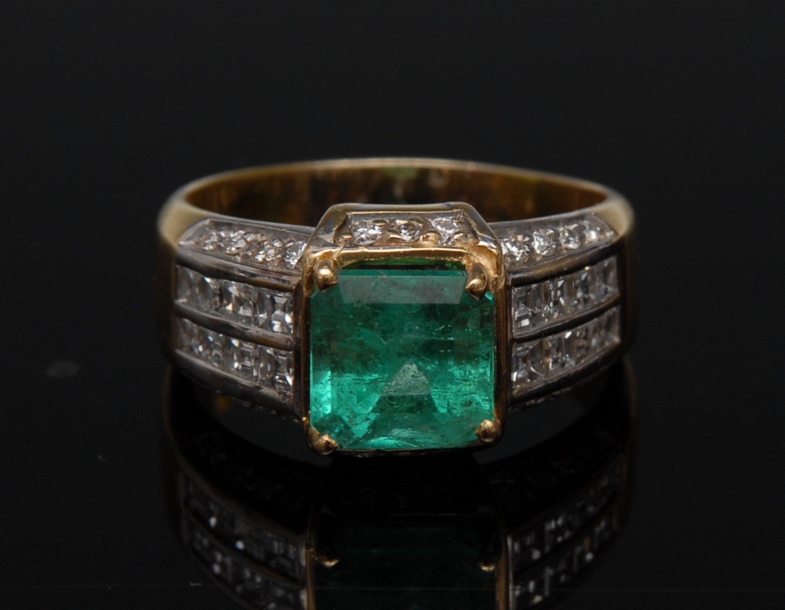 An emerald and diamond ring, central cushion cut emerald approx 2.