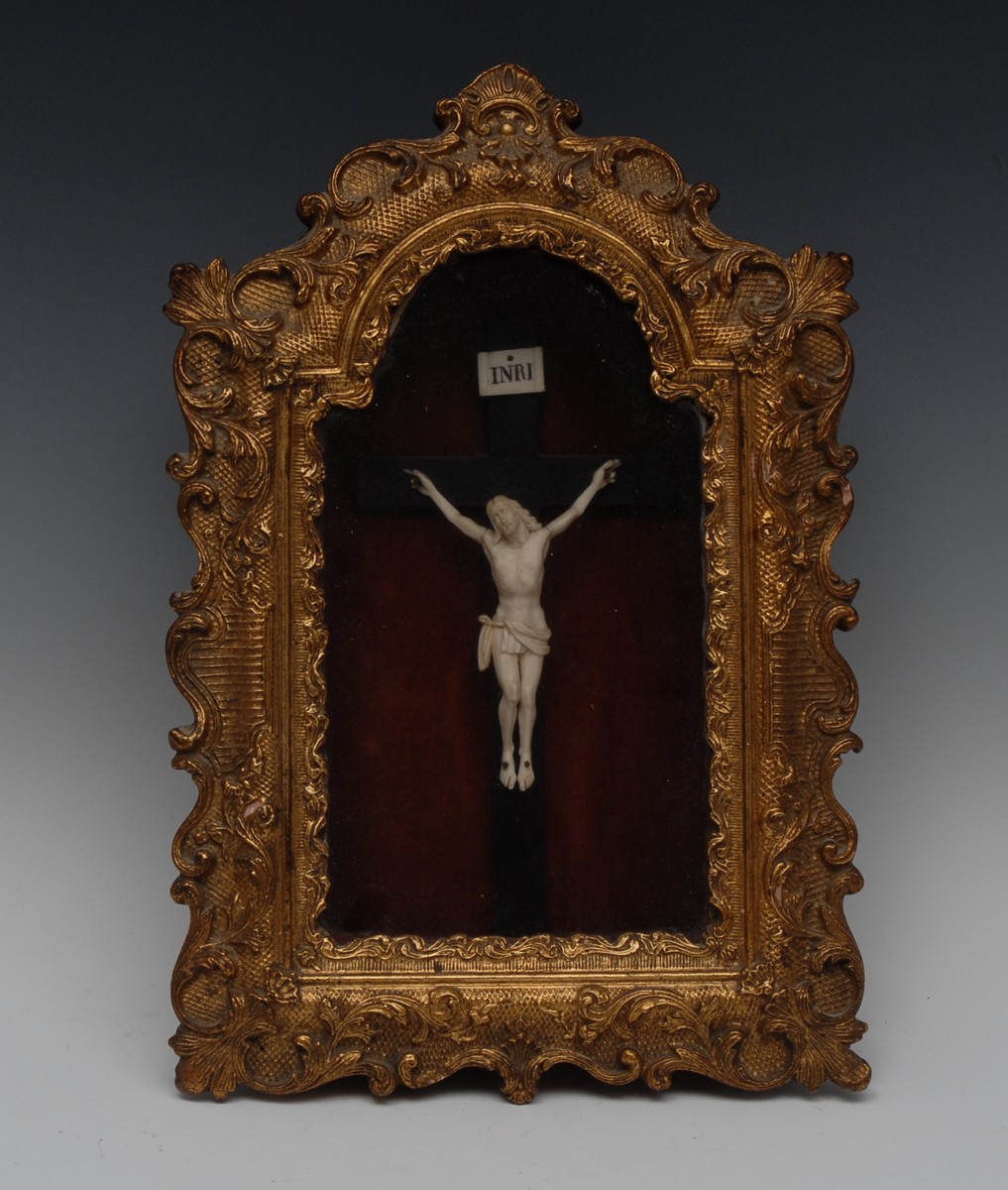 A 19th century French bone Corpus Christi, surmounted by a scroll inscribed with the acronym INRI,