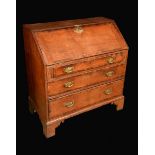 A George II oak bureau, fall front enclosing an arrangement of pigeon holes and small drawers,