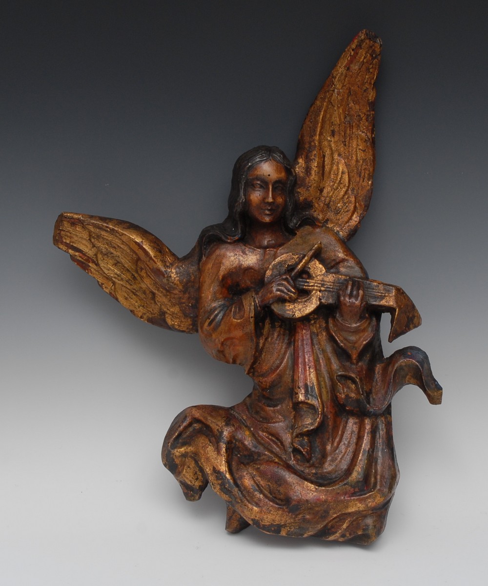 A 17th/18th century polychrome and gilt carving, of an angel playing a vielle, 49cm long, c.