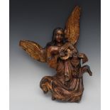 A 17th/18th century polychrome and gilt carving, of an angel playing a vielle, 49cm long, c.