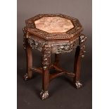 A Chinese padouk wood octagonal jardiniere stand, marble inset top with beaded border,