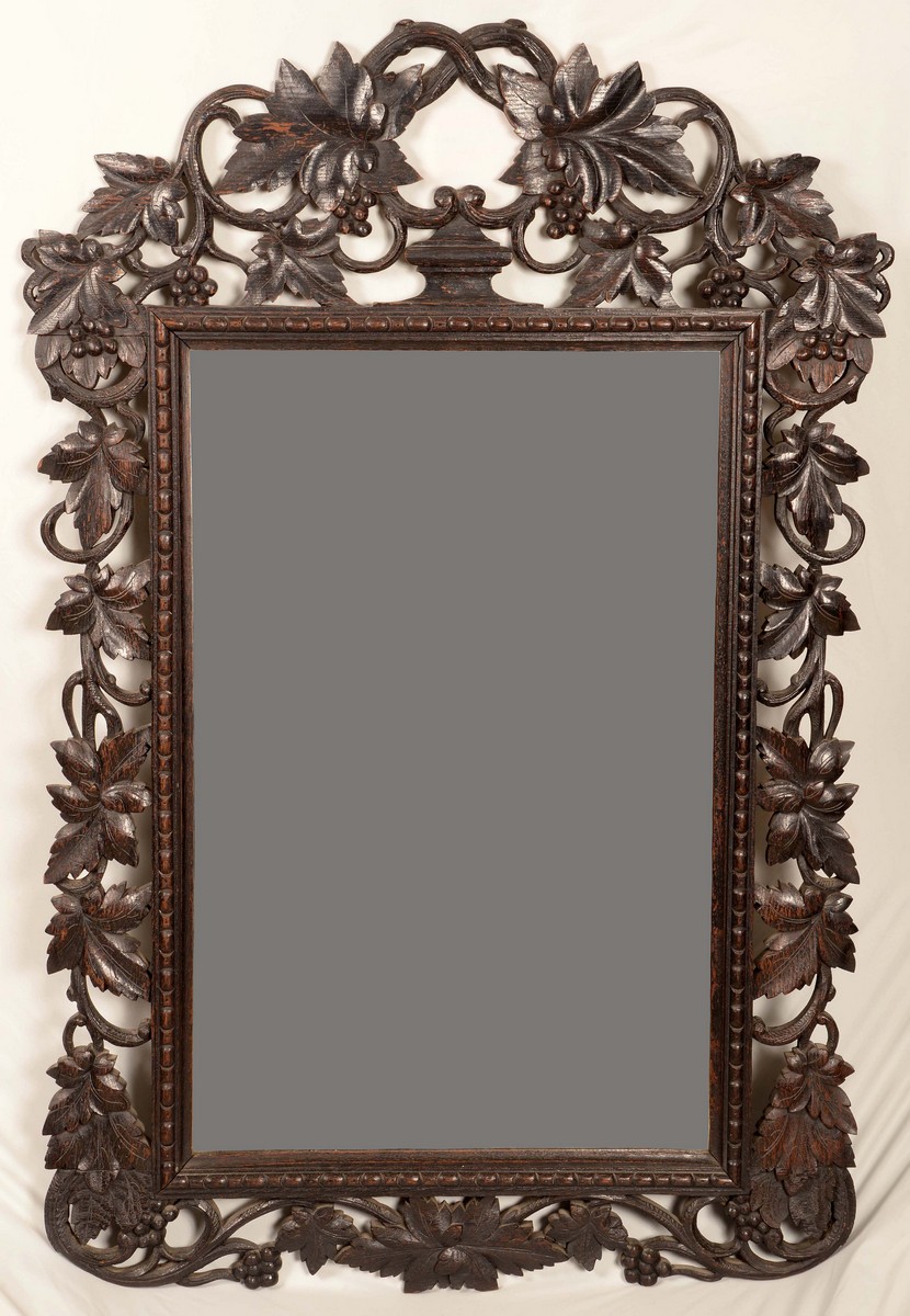 A Victorian oak shaped rectangular looking glass, pierced frame carved with scrolling fruiting vine,