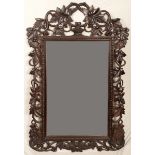 A Victorian oak shaped rectangular looking glass, pierced frame carved with scrolling fruiting vine,