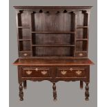 An '18th century' oak dresser, Greek key cornice above a shaped frieze, shelves and small drawers,