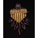An unusual amethyst and seed pearl brooch, scrolling topped central panel,