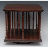 An Edwardian mahogany serpentine table top revolving bookcase, moulded and fluted borders,