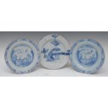 A pair of English Delft circular plates, decorated in underglaze blue with bridge,