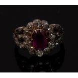 A ruby and diamond cluster ring, central oval ruby approx 1.