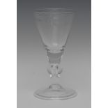 A large 18th century style wine glass, funnel shaped bowl, knopped tear drop stem,