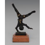 French School (19th century), a dark patinated and parcel-gilt bronze, of an acrobat,