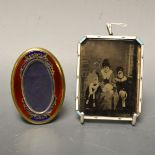 An Edwardian silver-gilt and enamel canted rectangular portrait miniature frame,