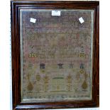 A mid 19th century sampler, embroidered with alphabet, verse and house,