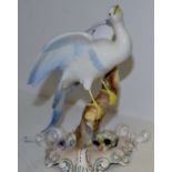 A Royal Crown Derby Chelsea bird, perched on a branch, picked out in blue, triform base,