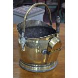 A Victorian brass coal scuttle with shovel