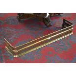 A George III pierced brass D-end brass fender. 18cm high x 123cm wide x 33cm deep.