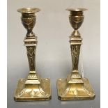 A pair of Edwardian Neo-Classical Revival silver candlesticks, detachable nozzles, urnular sconces,