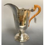 An Italian silver helmet shaped ewer, engine turned borders, planished overall,