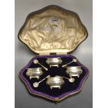 A set of four George V silver boat shaped salts, of George III design, gadrooned borders, ball feet,