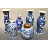 A harlequin garniture of three Chinese vases,