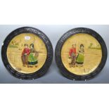 A pair of Bretby Art pottery Dutch girl and boy circular wall plaques (2)