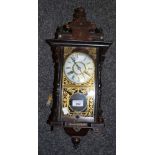 A 20th century wall clock, Roman numerals, eight day movement striking on a bell,