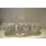 A silver plated twin handled tray; chased and engraved overall; a cut glass ships decanter;