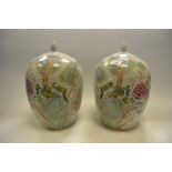 A pair of contemporary Chinese ginger jars and covers decorated with fanciful birds perched on