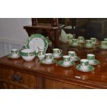 A Copeland part tea service, green border, painted with stylised flowers,