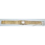 A lady's 9ct gold Summit wristwatch, bark effect strap,