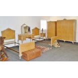 A French style seven piece burr walnut and pine bedroom suite, comprising triple wardrobe,