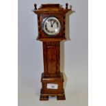 An early 20th century oak miniature mantel longcase clock