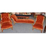 An Edwardian salon suite, comprising of a chaise longue; Gentleman's and Lady's Fireside chairs c.
