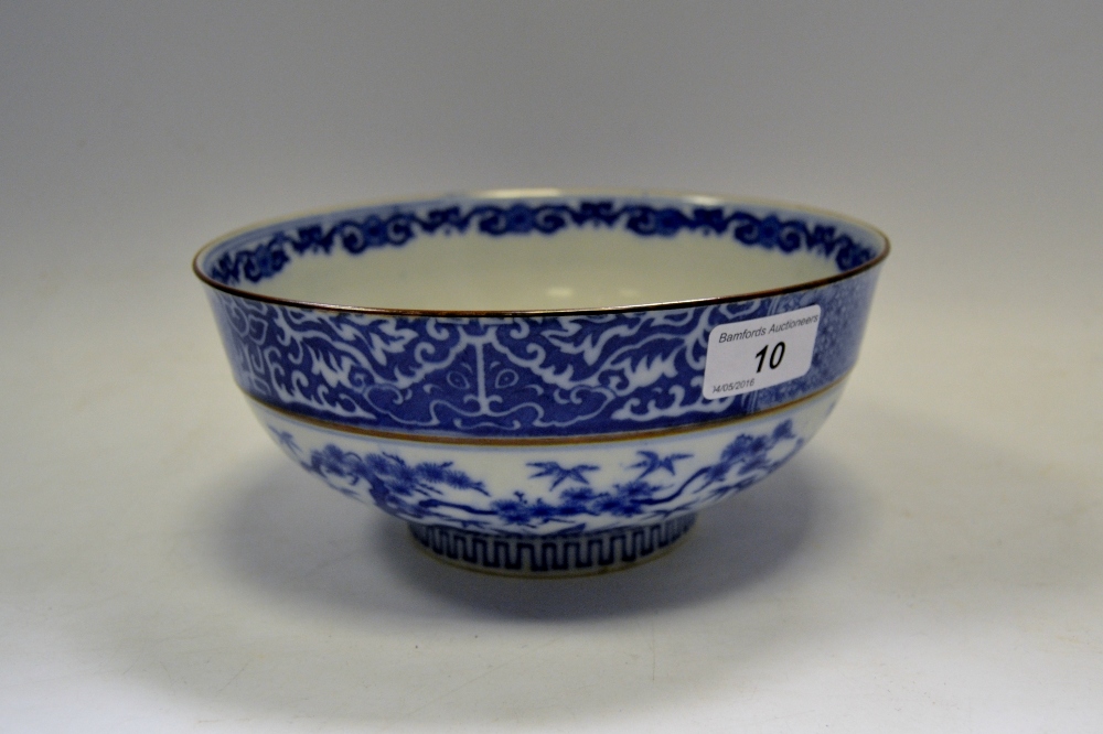 A Japanese Meiji period blue and white bowl decorated with flowering prunus and bamboo shoots,