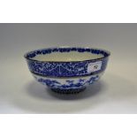 A Japanese Meiji period blue and white bowl decorated with flowering prunus and bamboo shoots,