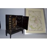 A Japanese lacquered jewellery cabinet on stand; a Royal Atlas map,
