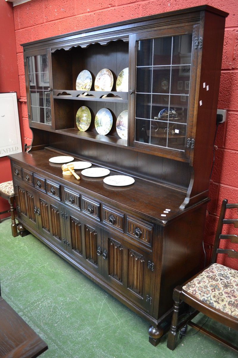 A large modern Miss Tudor oak dresser, supplied by Iron Gate Furnishings, Derby, stepped cornice,